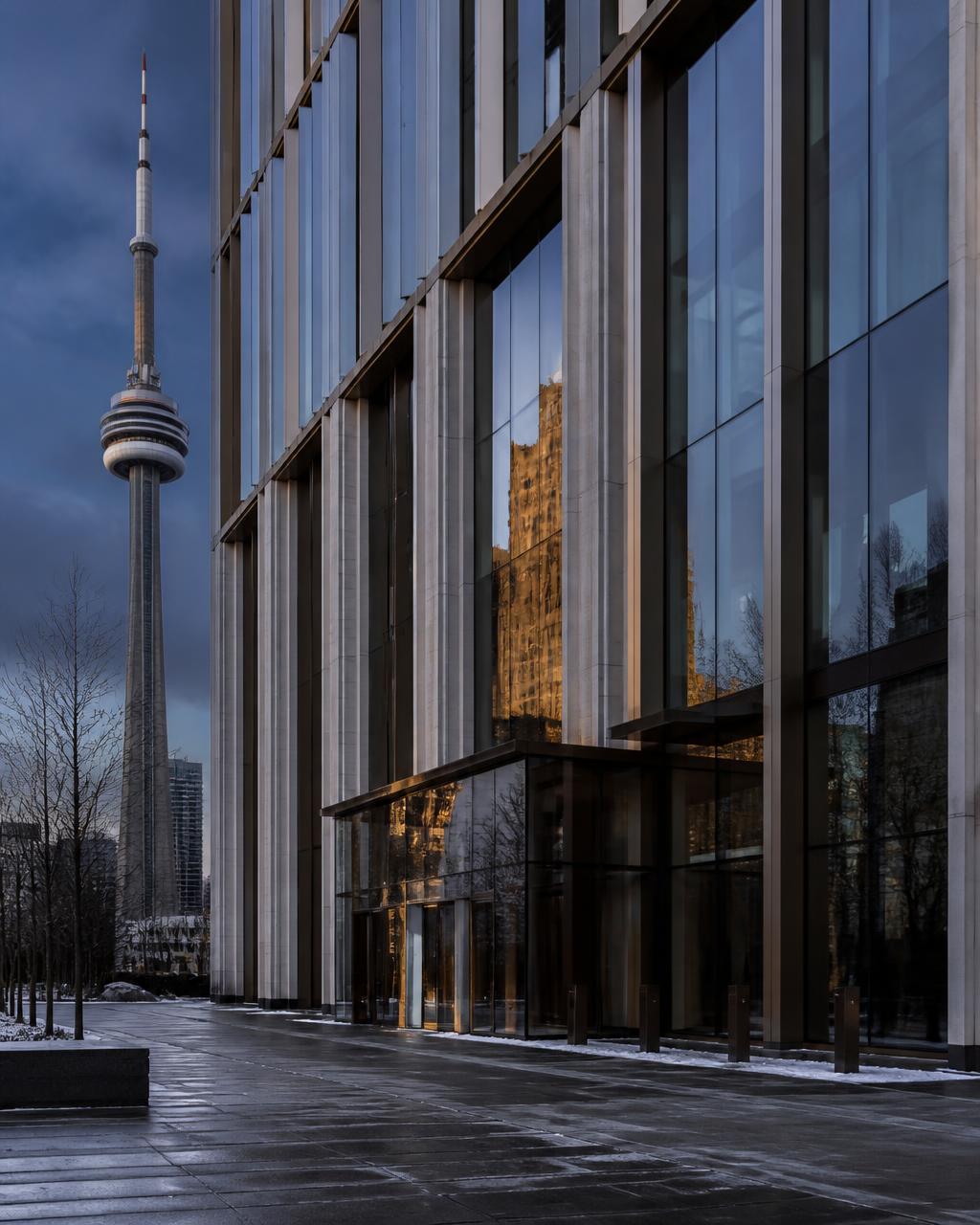 Glass and stone office tower in downtown Toronto at winter dusk